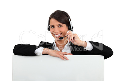 Woman with a headset and a board left blank for your message