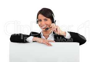 Woman with a headset and a board left blank for your message