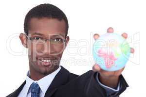 Businessman holding the world in the palm of his hand