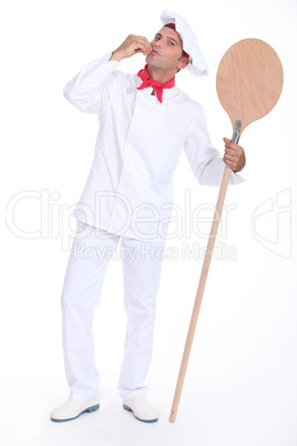 Pizza chef holding a pizza loading peel