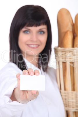 bakery worker holding out business card