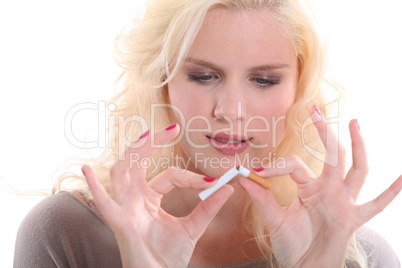 woman breaking a cigarette