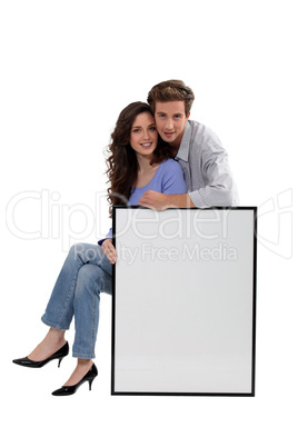 a couple and a white panel/ copyspace