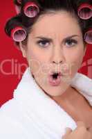 Angry woman with her hair in rollers