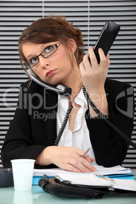 Secretary overwhelmed with two phones