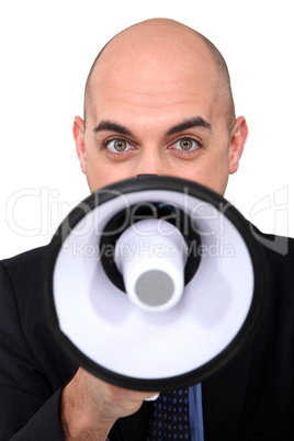 bald businessman speaking through  megaphone