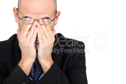 Tired businessman rubbing his eyes