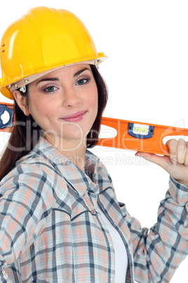 Female construction worker with a level.