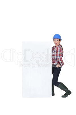 Female manual worker with blank advertisement