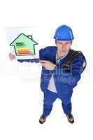 Stern tradesman giving a property an energy efficiency rating of G