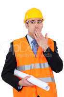 construction businessman putting a hand on his mouth