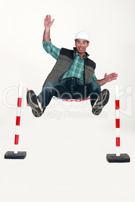 Man jumping over safety barrier