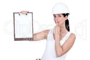 Woman with clip-board making shush gesture