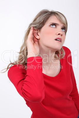 Woman with her hand to her ear