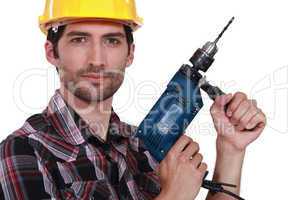 Tradesman holding an electric screwdriver