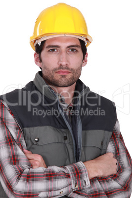 Builder stood with arms crossed