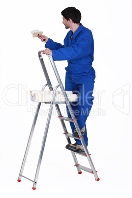 painter in jumpsuit on ladder isolated on white