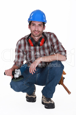 A kneeled handyman.