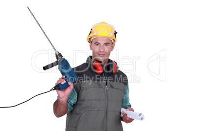 Man holding drill and plans