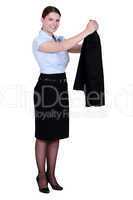A businesswoman taking off her jacket.