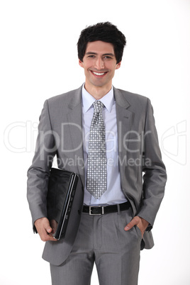 portrait of handsome young businessman all smiles with laptop
