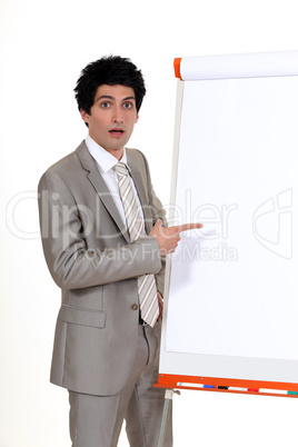 businessman pointing at a white board