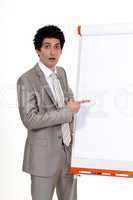 businessman pointing at a white board