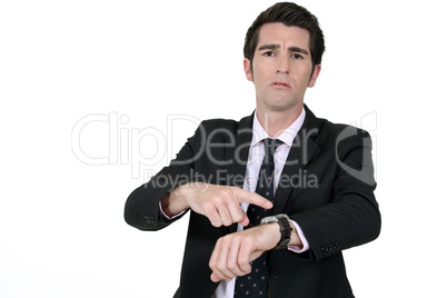 Businessman pointing at his watch