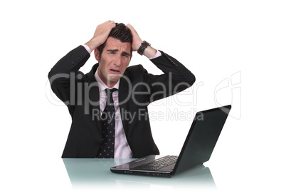 desperate businessman with laptop