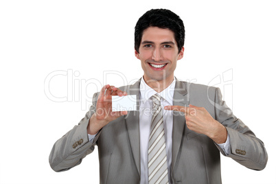 Young businessman pointing at card