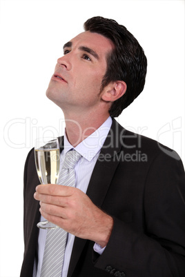 Businessman drinking champagne alone