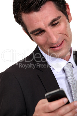 Businessman reading a text message