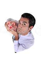 Man holding a piggy bank