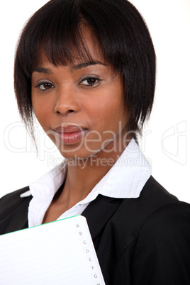 gorgeous black woman holding notebook with thumb index