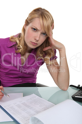 angry secretary working at her desk