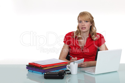 Woman swamped with paper work