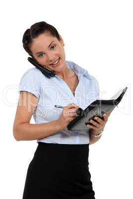 Businesswoman scheduling an appointment into her agenda