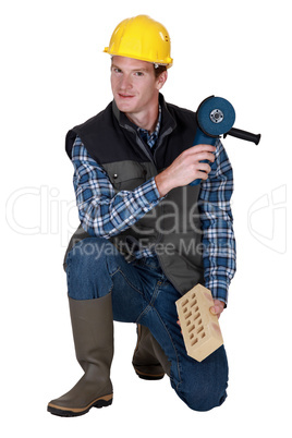 Worker with a brick and grinder