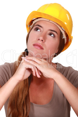 A pensive female construction worker.