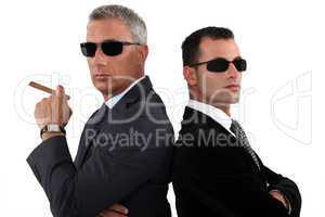 Powerful businessmen in sunglasses
