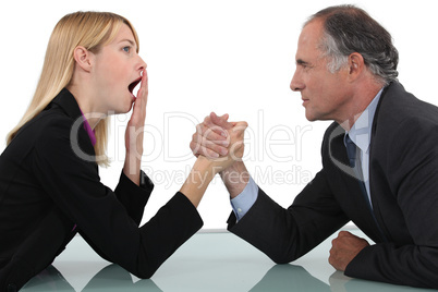 Woman arm wrestling with her boss