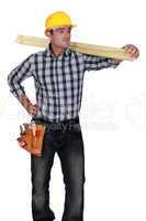 craftsman carrying a wooden board
