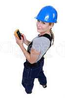 Female electrician with a voltmeter