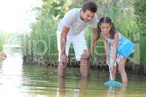 Father and daughter with a fishing net
