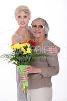 Granddaughter and grandmother with flowers