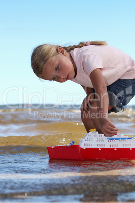 Girl playing with boat