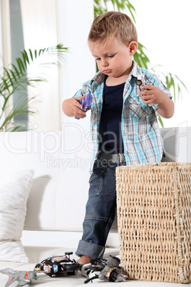 Little boy playing with toy cars