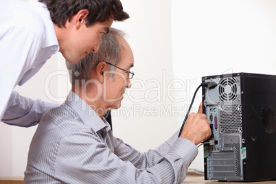 senior installing computer