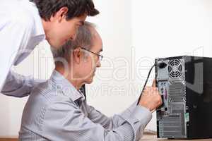 senior installing computer
