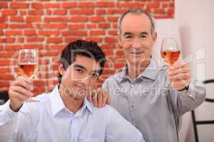 Two men drinking rose